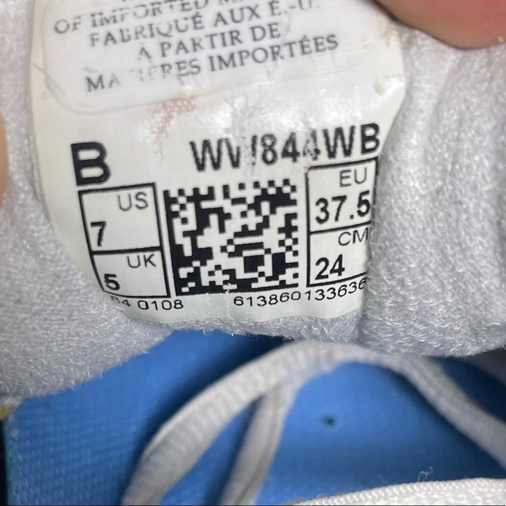 New Balance White Athletic Sneakers with Blue Accents